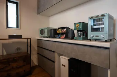 a kitchen with a counter with a microwave on it at Boasorte Urayasu in Tokyo