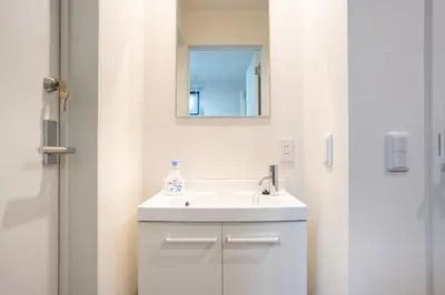 a bathroom with a white sink and a mirror at Boasorte Urayasu in Tokyo
