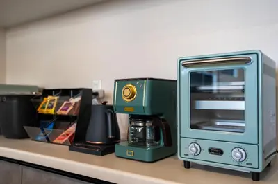 a kitchen counter with a coffee maker and a microwave at Boasorte Urayasu in Tokyo
