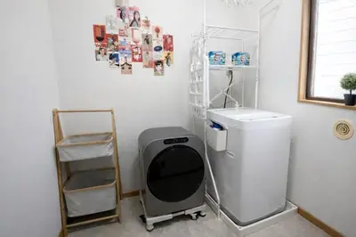 a laundry room with a washing machine and a shelf at Shibuya 5Bedroom Private Villa 2Bath 2WC Up to 14 Guests in Tokyo