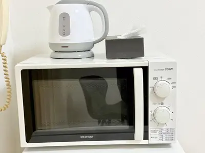 a blender sitting on top of a microwave at \u6c60\u888b Aurora 7 in Tokyo