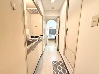 a hallway of a kitchen with a sink and a stove at \u6c60\u888b Aurora 7 in Tokyo