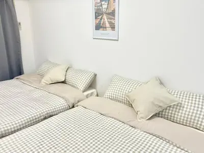 two beds sitting next to each other in a room at \u6c60\u888b Aurora 7 in Tokyo