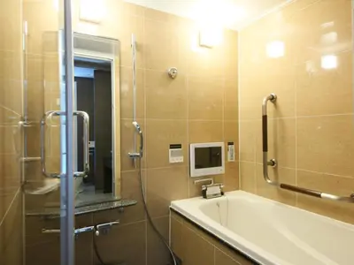 a bathroom with a shower and a tub and a sink at APA Hotel Asakusabashi Ekikita in Tokyo