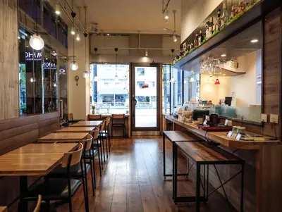 a restaurant with wooden tables and chairs and a bar at APA Hotel Asakusabashi Ekikita in Tokyo
