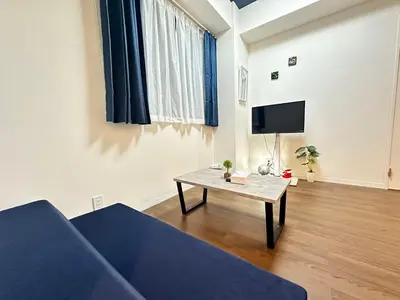 a living room with a couch and a table at SOLASIA residence \u5317\u4e0a\u91ce402 in Tokyo