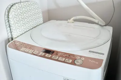 a washing machine with a remote control on top of it at NC-302Yamanote Line shinjuku \u9ad8\u7530\u99ac\u5834 5mins walk Hostel! \u9ad8\u901fWi-fi! Waseda in Tokyo