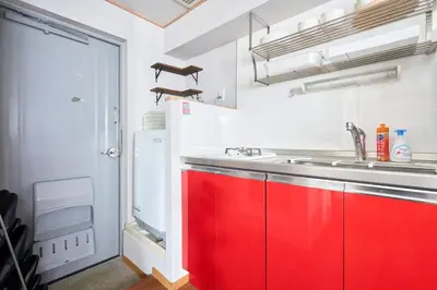 a kitchen with red cabinets and a sink at NC-302Yamanote Line shinjuku \u9ad8\u7530\u99ac\u5834 5mins walk Hostel! \u9ad8\u901fWi-fi! Waseda in Tokyo