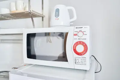a microwave oven sitting on top of a refrigerator at NC-302Yamanote Line shinjuku \u9ad8\u7530\u99ac\u5834 5mins walk Hostel! \u9ad8\u901fWi-fi! Waseda in Tokyo