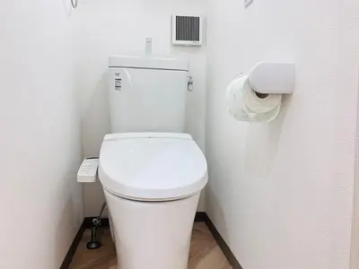 a white toilet in a bathroom with a roll of toilet paper at Sugamo 1F-TS0334 in Tokyo