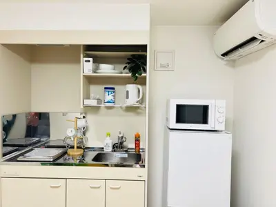 a kitchen with a white refrigerator and a microwave at Sugamo 1F-TS0334 in Tokyo