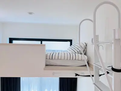 a bedroom with a white bunk bed with a window at Sugamo 1F-TS0334 in Tokyo