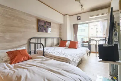 a room with two beds and a tv in it at ND-307Yamanote Line shinjuku \u9ad8\u7530\u99ac\u5834 5mins walk Hostel!\u9ad8\u901fWi-fi! Waseda in Tokyo