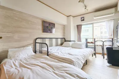 two beds in a room with white sheets at ND-307Yamanote Line shinjuku \u9ad8\u7530\u99ac\u5834 5mins walk Hostel!\u9ad8\u901fWi-fi! Waseda in Tokyo