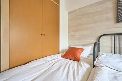 a bedroom with a bed with an orange pillow on it at ND-307Yamanote Line shinjuku \u9ad8\u7530\u99ac\u5834 5mins walk Hostel!\u9ad8\u901fWi-fi! Waseda in Tokyo