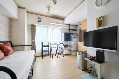 a room with a bed and a television and a kitchen at ND-307Yamanote Line shinjuku \u9ad8\u7530\u99ac\u5834 5mins walk Hostel!\u9ad8\u901fWi-fi! Waseda in Tokyo