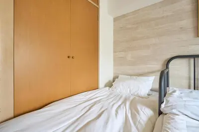 a bedroom with a bed with a wooden headboard at ND-307Yamanote Line shinjuku \u9ad8\u7530\u99ac\u5834 5mins walk Hostel!\u9ad8\u901fWi-fi! Waseda in Tokyo