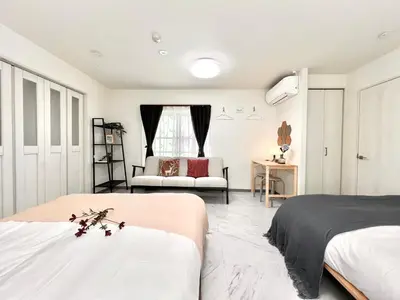 a bedroom with two beds and a couch at Sugamo 3F-TS0336 in Tokyo