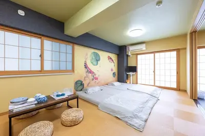 a bedroom with a large bed and a table at \u5409\u7965\u5929 in Tokyo