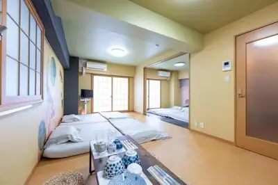 a room with two beds and a table in it at \u5409\u7965\u5929 in Tokyo
