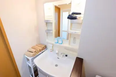 a white bathroom with a sink and a mirror at \u5409\u7965\u5929 in Tokyo
