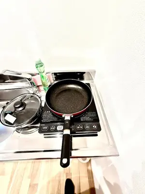 a frying pan sitting on top of a stove at Asakusa Stay Hotel in Tokyo