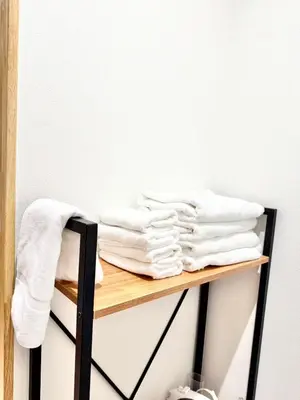 a pile of towels on a shelf in a room at Asakusa Stay Hotel in Tokyo