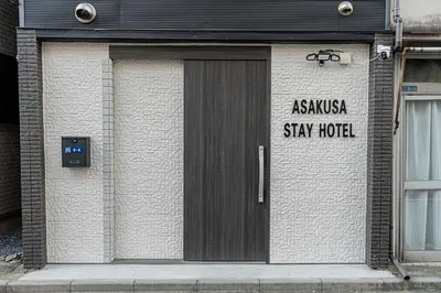 a door to a building with a sign on it at Asakusa Stay Hotel in Tokyo