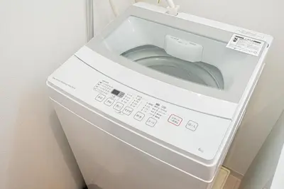 a white washer and dryer in a refrigerator at Asakusa Stay Hotel in Tokyo
