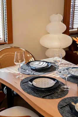a wooden table with plates and wine glasses on it at \u6e0b\u8c37\u99c5\u5f92\u6b69 10\u5206 \u4ee3\u5b98\u5c717\u5206 3LDK90m \u9ad8\u7d1a\u4f4f\u5b85\u5c4b\u4e0a\u4ed8\u304d \u96fb\u8eca\u3067\u8868\u53c2\u90532\u5206\u9280\u5ea715\u5206\u65b0\u5bbf5\u5206 in Tokyo