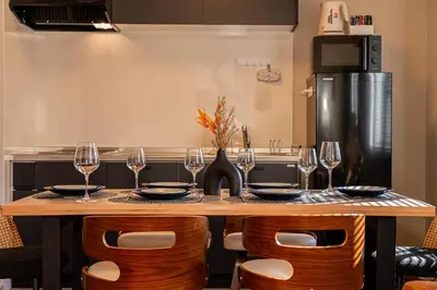 a kitchen with a table with wine glasses at \u6e0b\u8c37\u99c5\u5f92\u6b69 10\u5206 \u4ee3\u5b98\u5c717\u5206 3LDK90m \u9ad8\u7d1a\u4f4f\u5b85\u5c4b\u4e0a\u4ed8\u304d \u96fb\u8eca\u3067\u8868\u53c2\u90532\u5206\u9280\u5ea715\u5206\u65b0\u5bbf5\u5206 in Tokyo