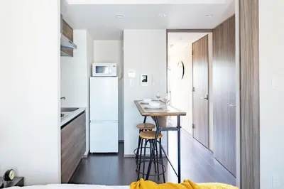 a small kitchen with a small table in a small apartment at Dash Living Osaki in Tokyo