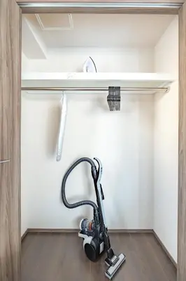 a vacuum in a room with a shelf at Dash Living Osaki in Tokyo