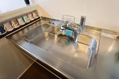 a stainless steel kitchen sink with a faucet at Takasago Utopia Hotel in Tokyo