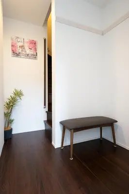 a bench in the corner of a room at Takasago Utopia Hotel in Tokyo