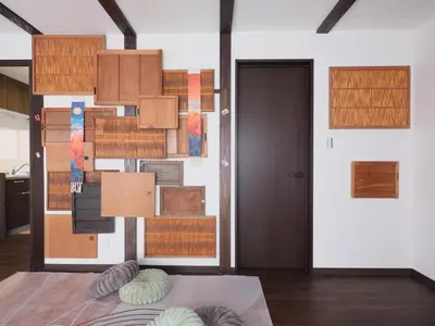 a room with a wall with wooden cabinets at mori HOUSE-vacation rental in Tokyo