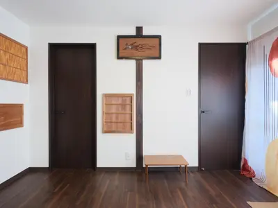 a room with two doors and a clock on the wall at mori HOUSE-vacation rental in Tokyo
