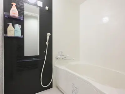 a bathroom with a white toilet and a mirror at mori HOUSE-vacation rental in Tokyo