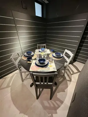 a dining room table with chairs and a black table and chairsktop at Worldtraveler Roppongi in Tokyo