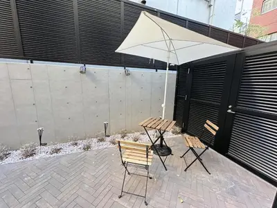 a table and two chairs and an umbrella on a patio at Worldtraveler Roppongi in Tokyo