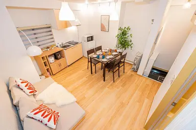 a living room with a couch and a table at Aurora1 in Tokyo