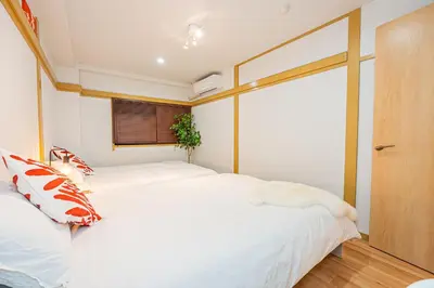 a bedroom with two beds and a window at Aurora1 in Tokyo