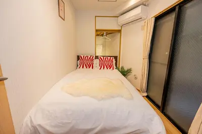 a bedroom with a large white bed in a room at Aurora1 in Tokyo