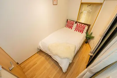 a small bedroom with a bed in a room at Aurora1 in Tokyo