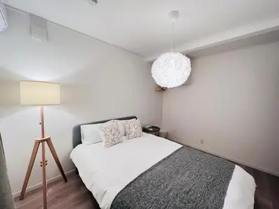 a small bedroom with a bed and a lamp at Higashinakano House NN0021 in Tokyo