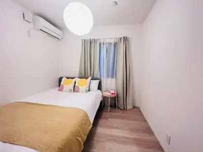 a small bedroom with a bed and a window at Higashinakano House NN0021 in Tokyo