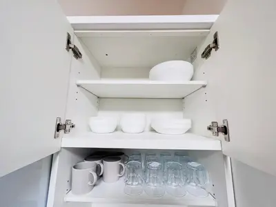 a cabinet filled with glasses and bowls and cups at Higashinakano House NN0021 in Tokyo