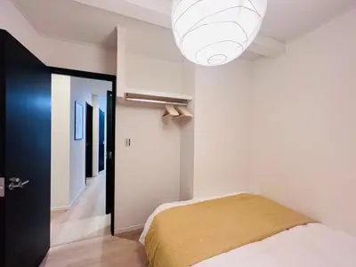 a bedroom with a bed and a light at Higashinakano House NN0021 in Tokyo