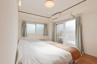 a bedroom with a bed and a large window at V Close to Shinjuku Kabukicho Korean Town FrWIFI J in Tokyo