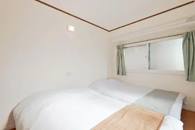 a bedroom with two beds and a window at V Close to Shinjuku Kabukicho Korean Town FrWIFI J in Tokyo